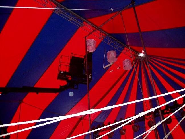 Sebastien Amiri rigging space lights in a circus tent for CSI-NY (Photo by Dennis K. Grow)
